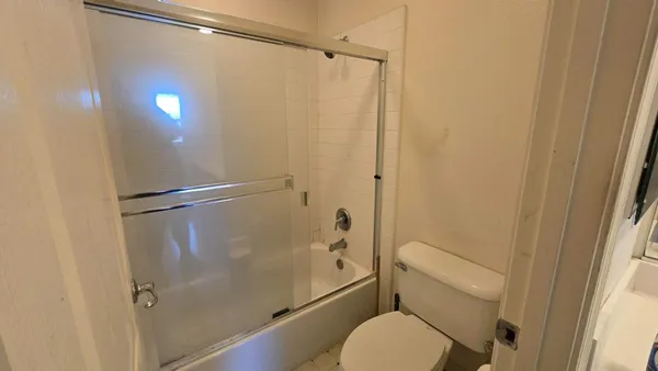 a bathroom with a toilet and a shower