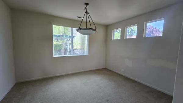 a view of room with window and ceiling fan