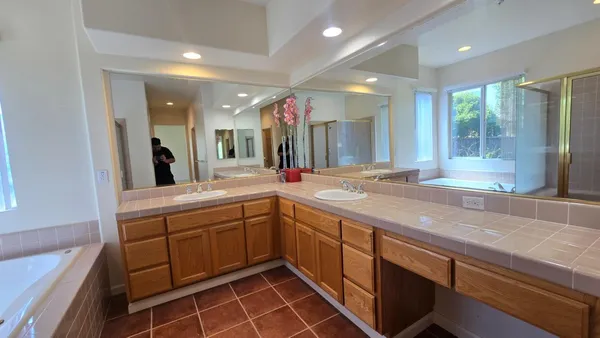 a spacious bathroom with a sink and a large mirror