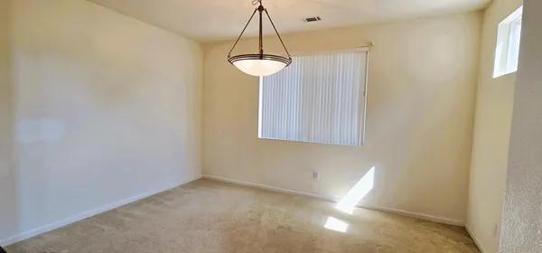 a view of a room with a window and chandelier