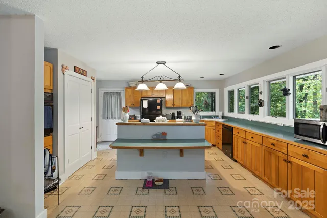 a living room with a sink and a large window