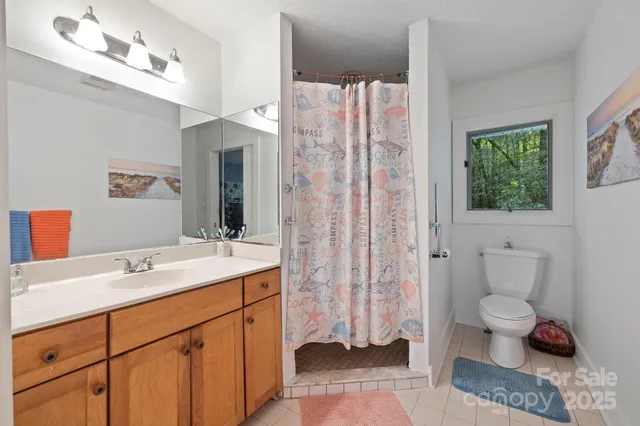 a spacious bathroom with a sink toilet and shower