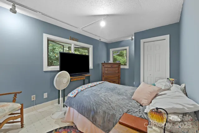 a bedroom with bed and window