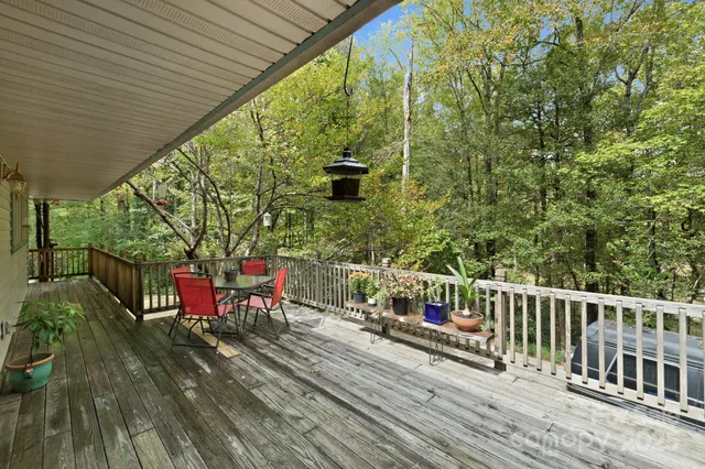 a view of a chairs and table on the wooden deck