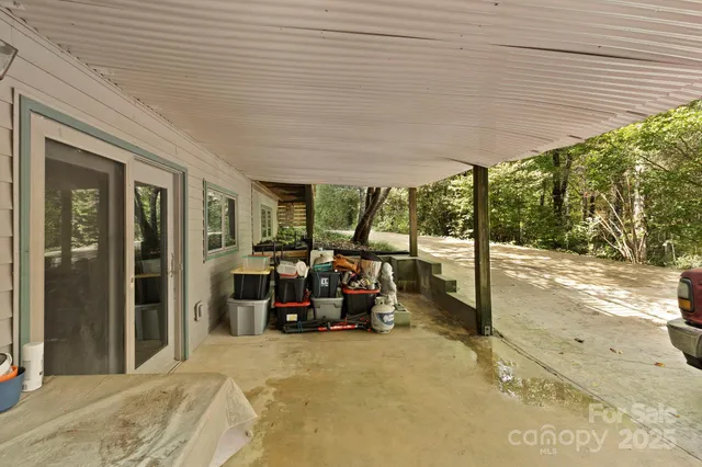 a view of a patio with table and chairs under an umbrella