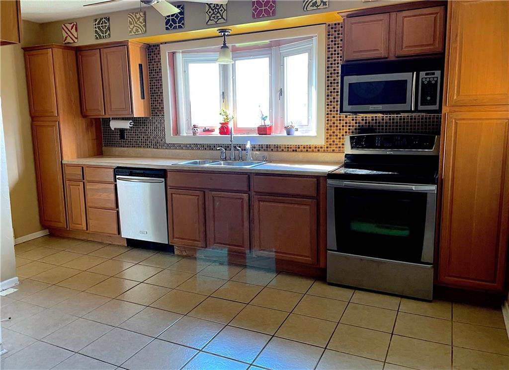 717 Morgantown Road Uniontown, PA 15401 - Photo 7 of 18 a kitchen with a stove sink and microwave