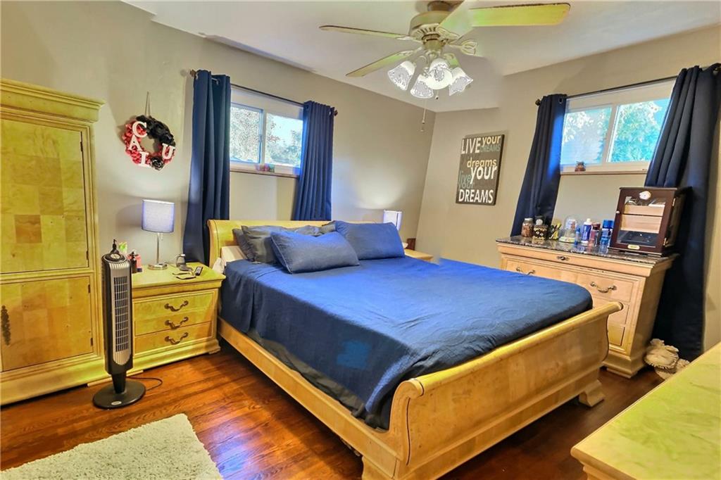 717 Morgantown Road Uniontown, PA 15401 - Photo 9 of 18 a bedroom with a bed and a chandelier