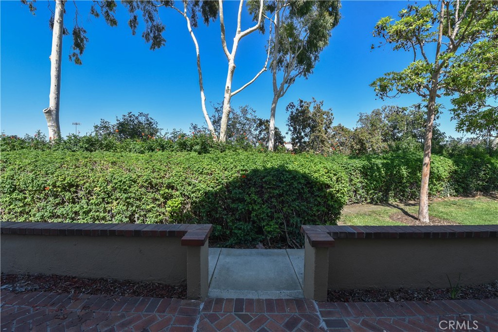 55 Wellesley, Unit 55 Irvine, CA 92612 - Photo 4 of 11 a view of a yard with plants and a table and chair