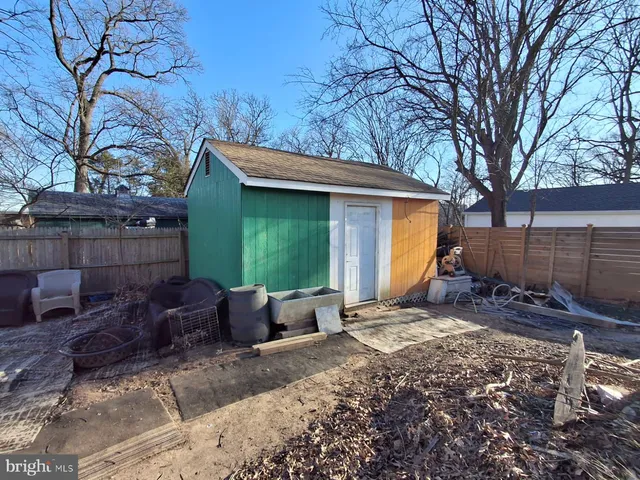 a view of a chair and table in backyard