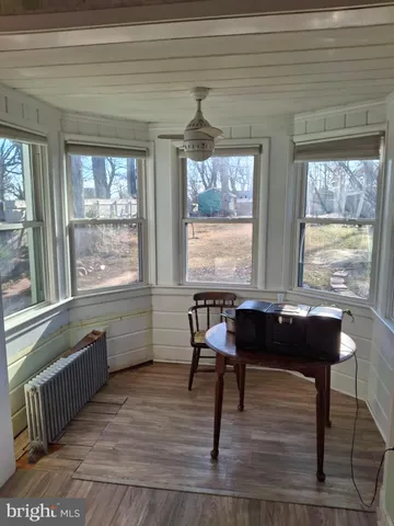 a room with wooden floor and a window