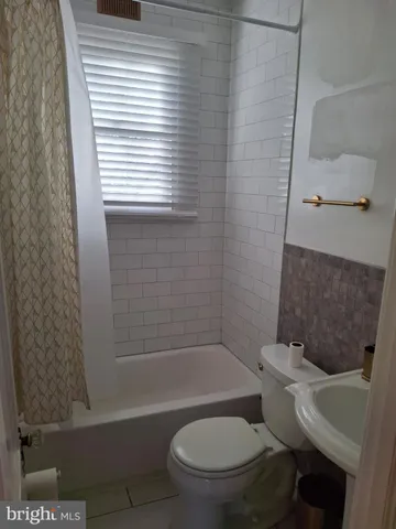 a bathroom with a toilet a sink and bathtub