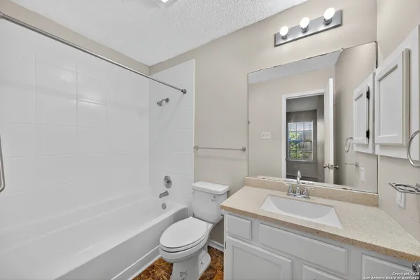 a bathroom with a sink toilet a mirror and shower