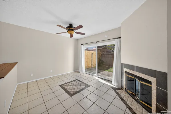a view of an empty room with a fireplace