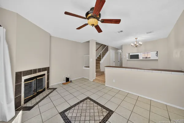 a view of an empty room and kitchen view