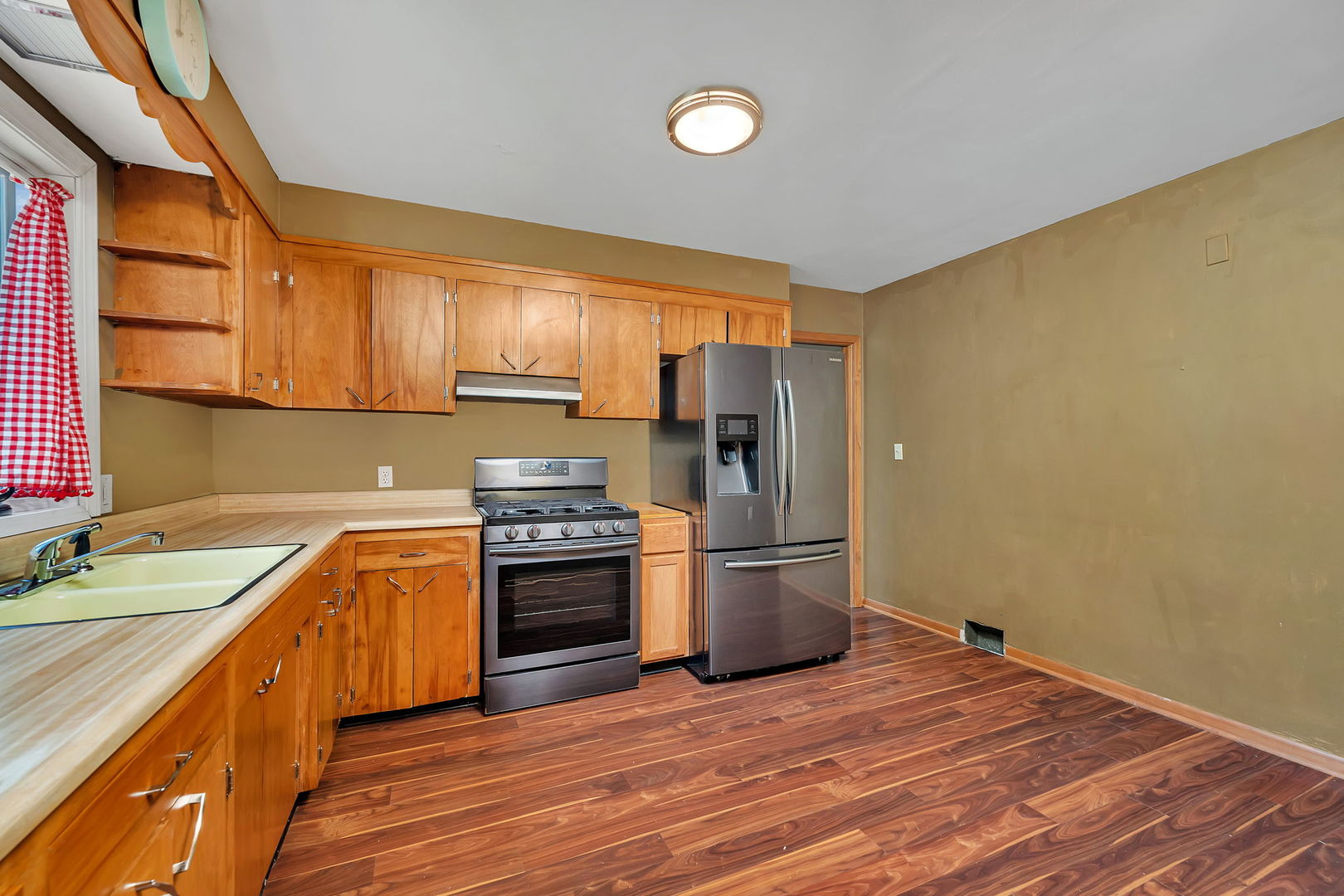 536 Fort Street Ottawa, IL 61350 - Photo 13 of 30 a kitchen with stainless steel appliances granite countertop a refrigerator a sink dishwasher a stove with wooden cabinets and floors