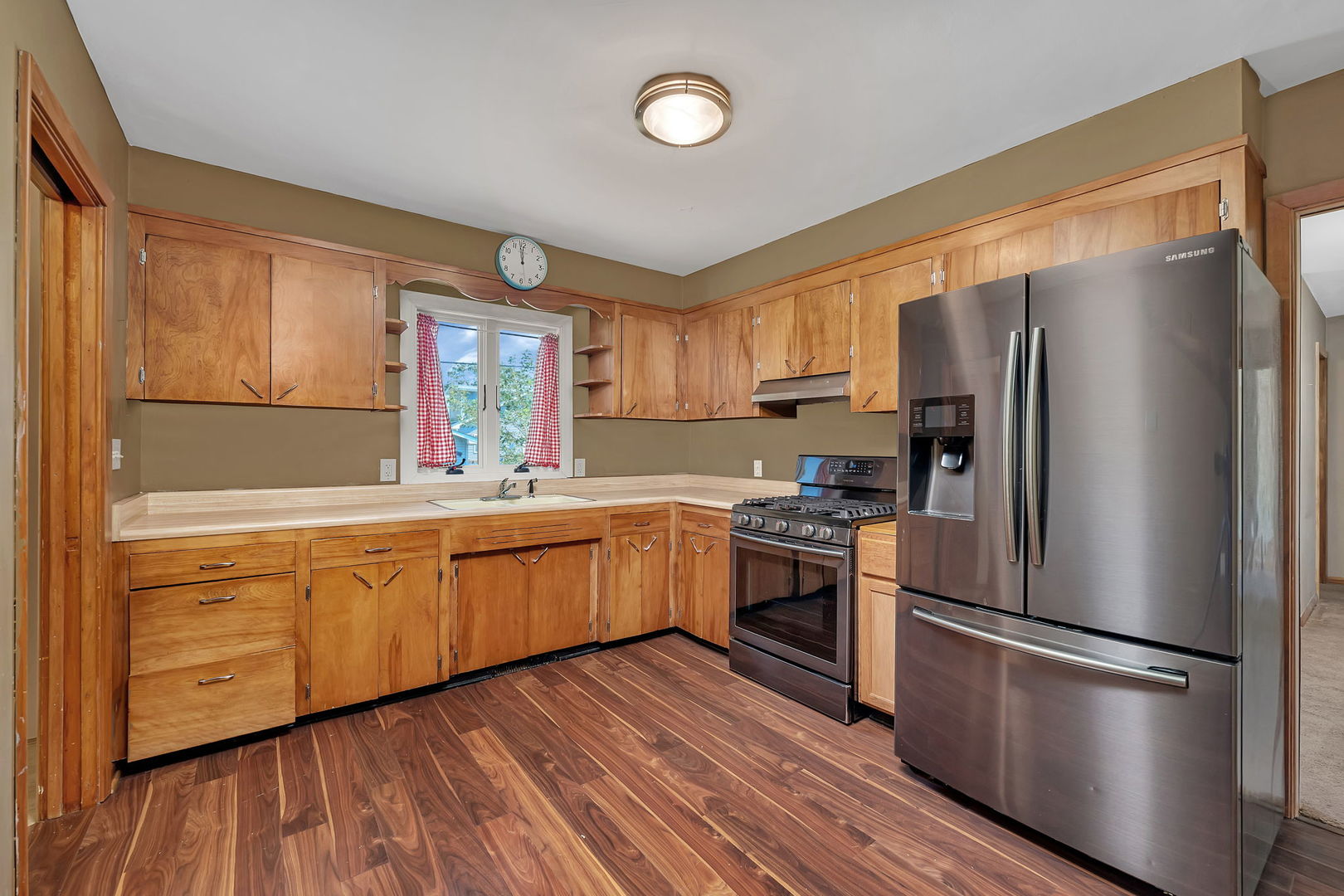 536 Fort Street Ottawa, IL 61350 - Photo 9 of 30 a kitchen with granite countertop stainless steel appliances a refrigerator cabinets and wooden floor