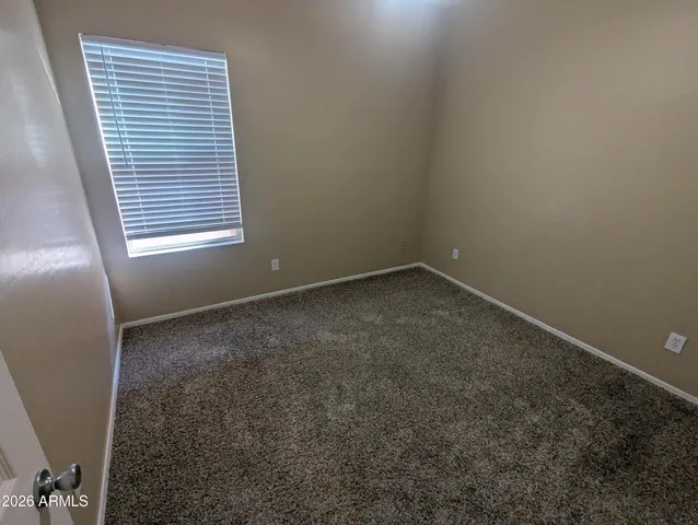 a bathroom with a granite countertop sink a toilet a mirror and shower