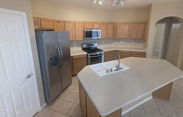 a kitchen with stainless steel appliances a refrigerator and a stove