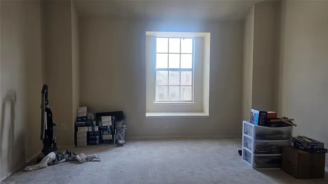 an empty room with furniture and windows