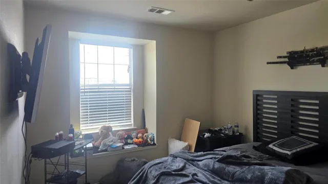 a bedroom with a bed and a window
