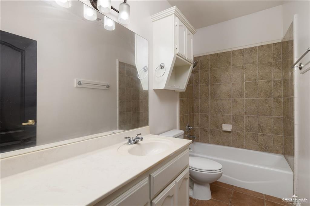 1311 East 28th Street Mission, TX 78574 - Photo 12 of 19 a bathroom with a sink a toilet and shower