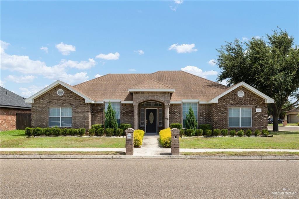 1311 East 28th Street Mission, TX 78574 - Photo 2 of 19 a front view of a house with a yard and large trees