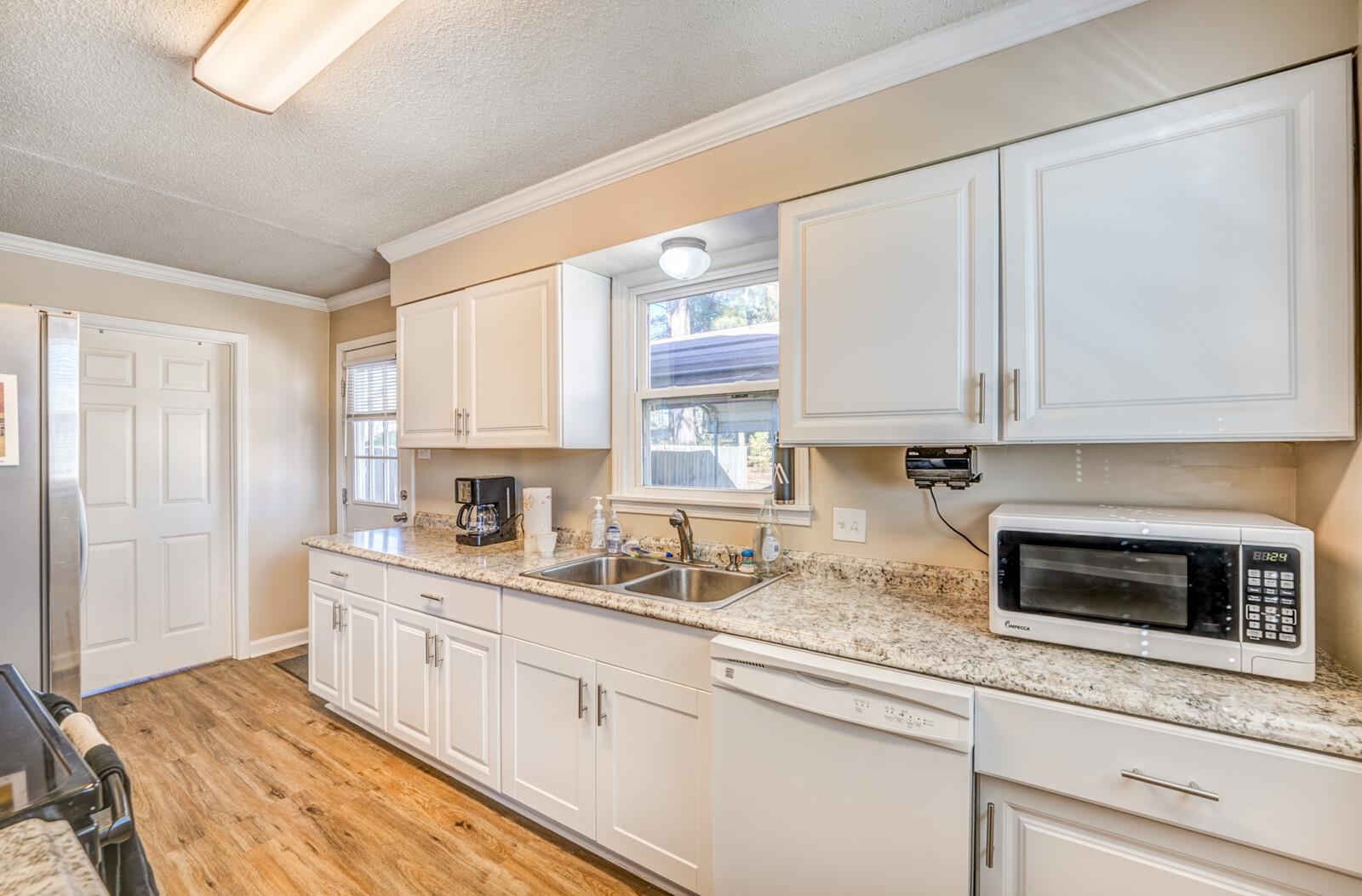 11060 Memphis Arlington Road Arlington, TN 38002 - Photo 3 of 25 a kitchen with stainless steel appliances granite countertop white cabinets a sink and a window
