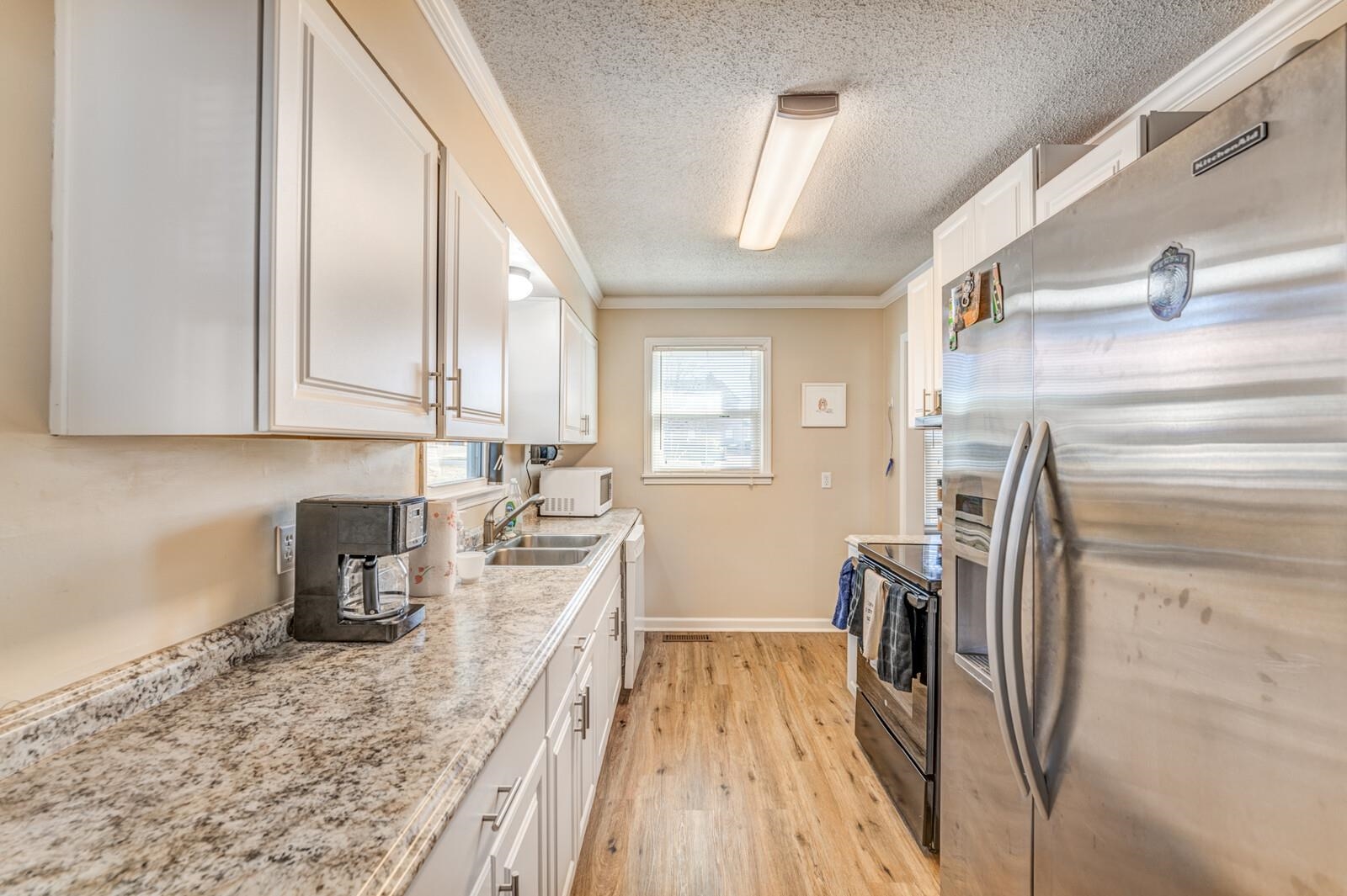 11060 Memphis Arlington Road Arlington, TN 38002 - Photo 6 of 25 a kitchen with sink a refrigerator and washer