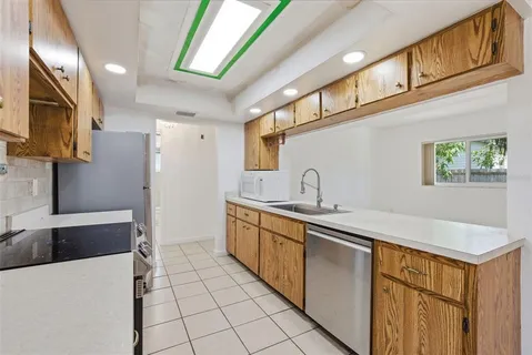 a kitchen with stainless steel appliances a sink stove and cabinets