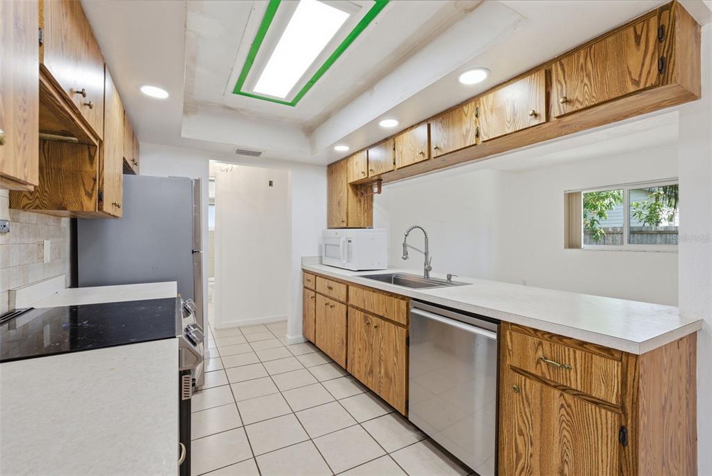 4536 Webber Street Sarasota, FL 34232 - Photo 10 of 45 a kitchen with stainless steel appliances a sink stove and cabinets