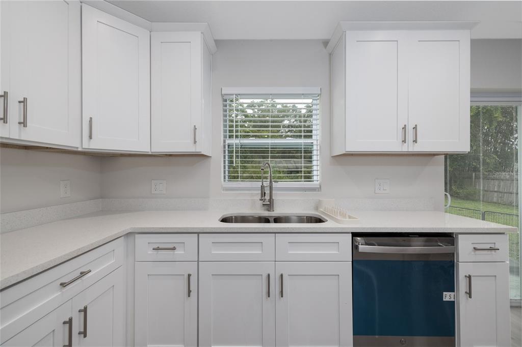 1171 9th Street Orange City, FL 32763 - Photo 16 of 27 a kitchen with appliances cabinets and a window
