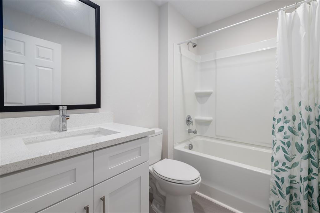 1171 9th Street Orange City, FL 32763 - Photo 19 of 27 a bathroom with a sink a toilet and a bathtub
