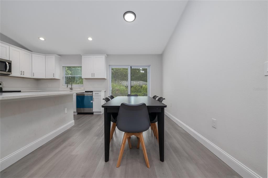 1171 9th Street Orange City, FL 32763 - Photo 21 of 27 a kitchen with a table and chairs in it
