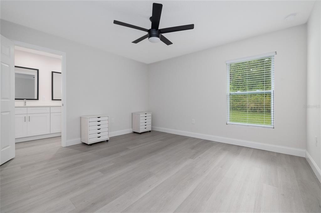 1171 9th Street Orange City, FL 32763 - Photo 23 of 27 a view of an empty room with a window and a ceiling fan