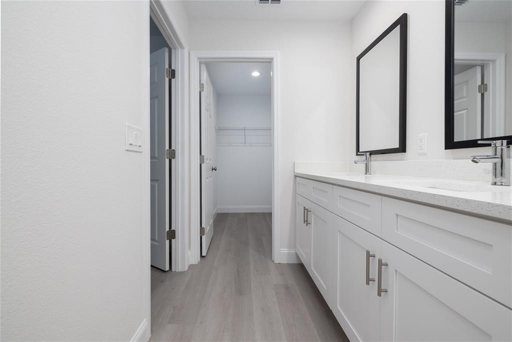 1171 9th Street Orange City, FL 32763 - Photo 26 of 27 a bathroom with a double vanity sink and mirror
