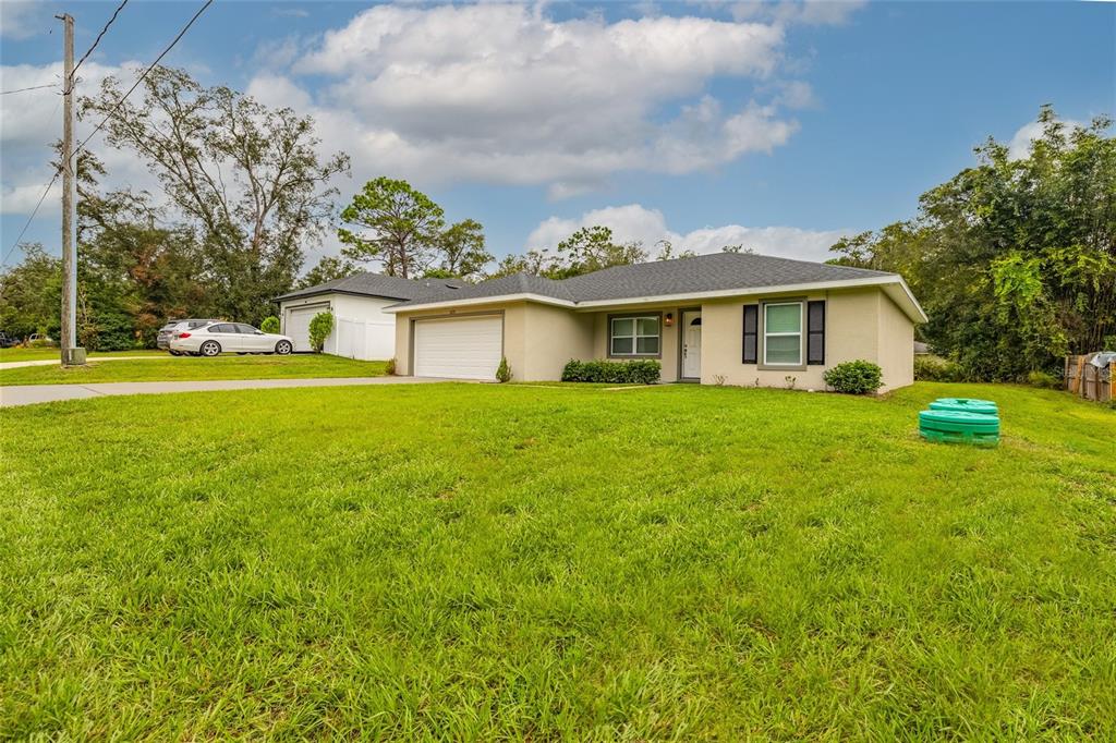 1171 9th Street Orange City, FL 32763 - Photo 3 of 27 a front view of house with yard and green space