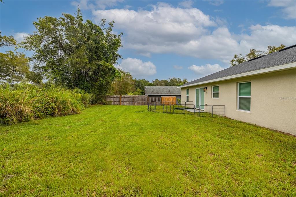 1171 9th Street Orange City, FL 32763 - Photo 7 of 27 a backyard of a house with table and chairs
