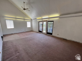 3013 North 100 West Provo, UT 84604 - Photo 3 of 18 Empty room featuring high vaulted ceiling, dark carpet, and a ceiling fan