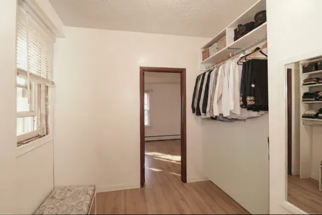 a bedroom with a bed and a mirror