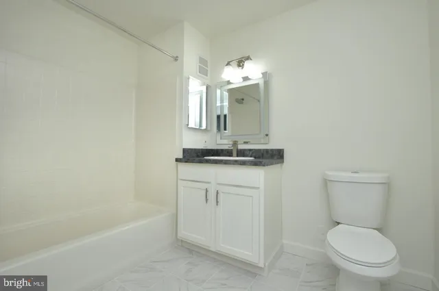 a bathroom with a toilet a sink and bathtub