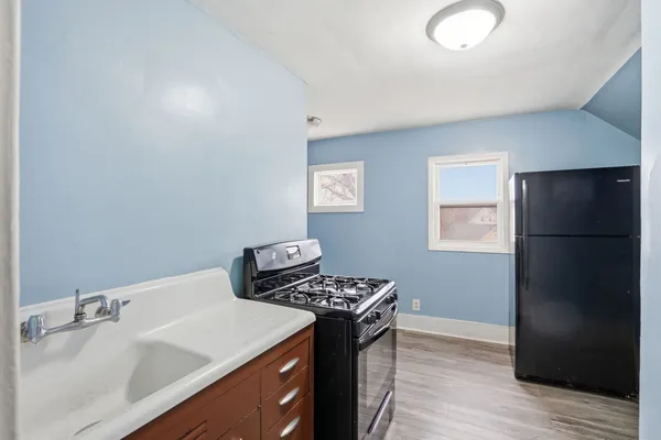 a kitchen with a refrigerator and a sink