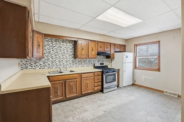 a kitchen with stainless steel appliances granite countertop a sink stove and refrigerator