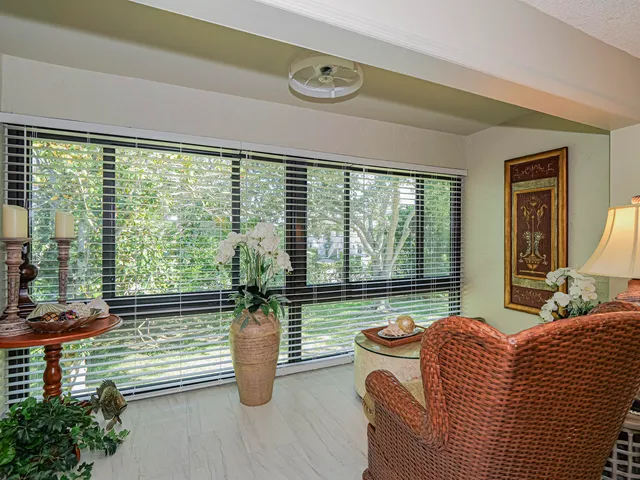 a bedroom with furniture and a large window