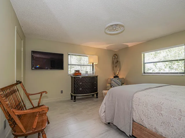 a bedroom with a large bed and a chandelier