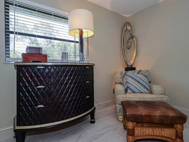 a bedroom with a bed and a large mirror on dresser