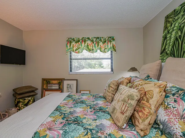 a bedroom with furniture and a large window