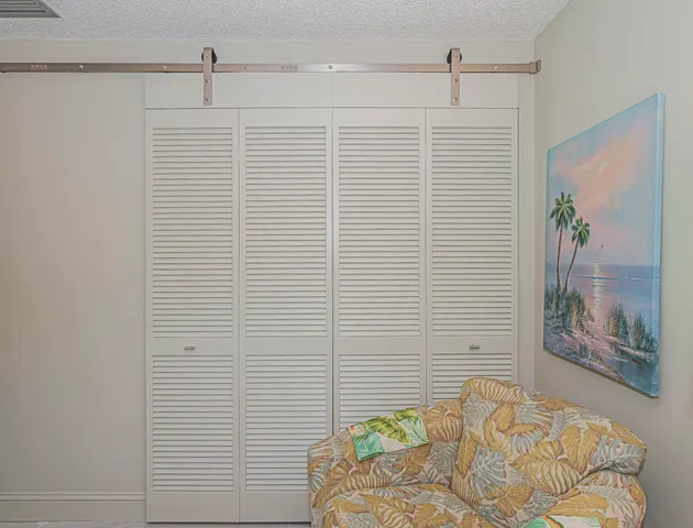 a bathroom with a granite countertop shower sink vanity and mirror