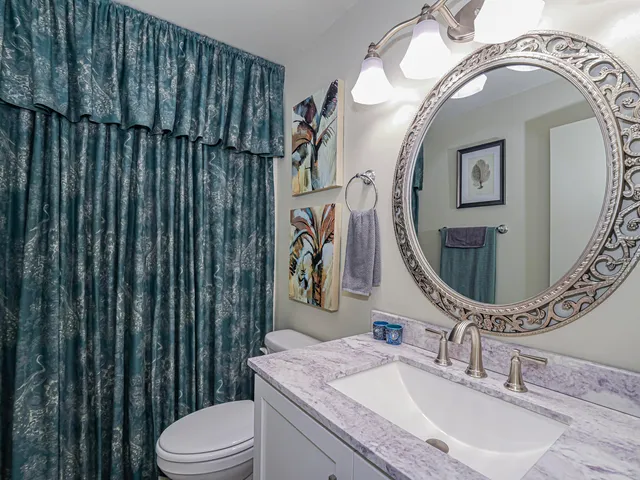 a bathroom with a granite countertop shower and a sink