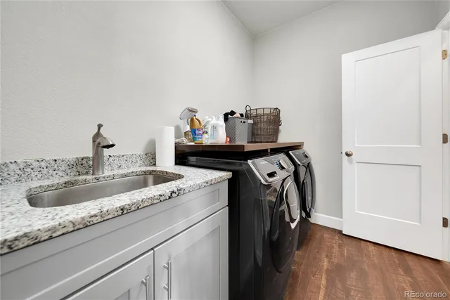 a utility room with faucet washer and dryer