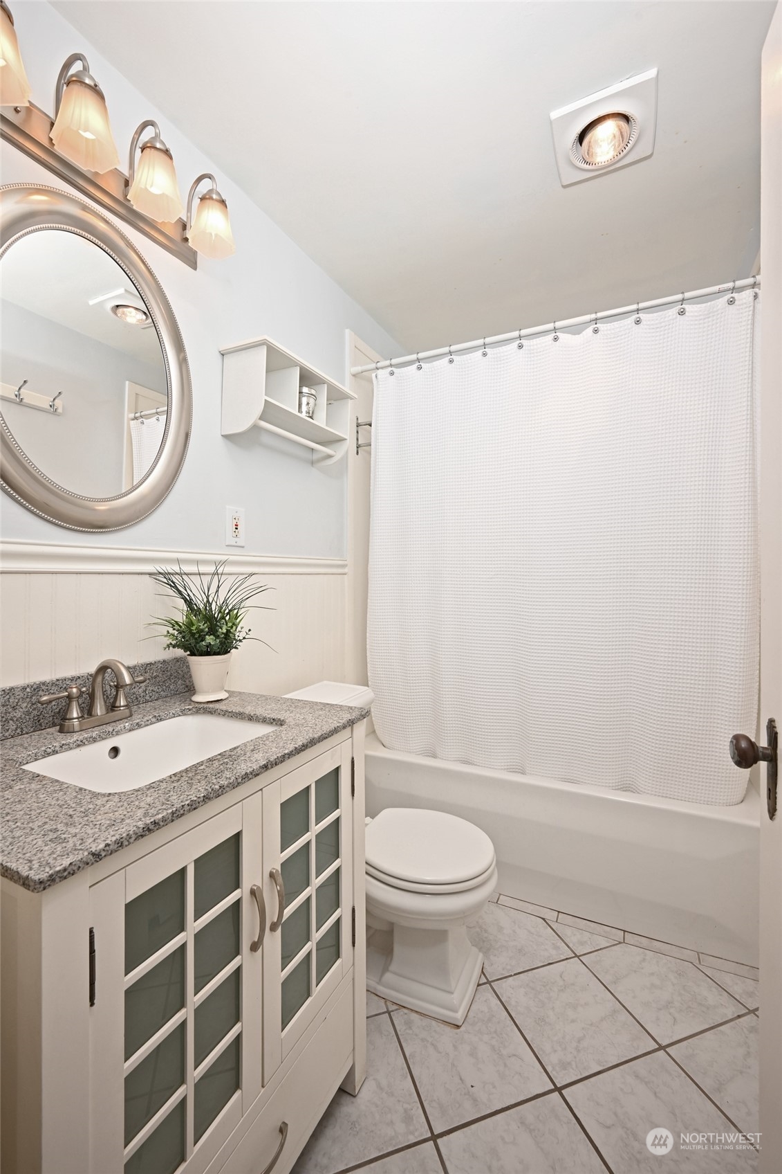 312 Northeast 95th Street Seattle, WA 98115 - Photo 18 of 37 a bathroom with a granite countertop sink a toilet and a mirror